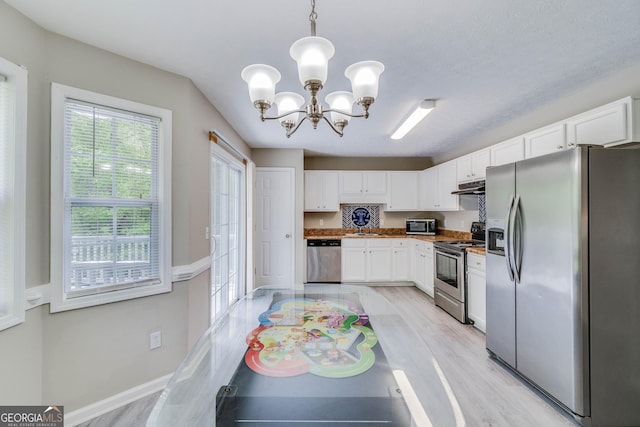 236 Fairview Dr, Dallas, GA 30157 - kitchen featuring stainless steel appliances, under cabinet range hood, a chandelier, white cabinetry, and a sink