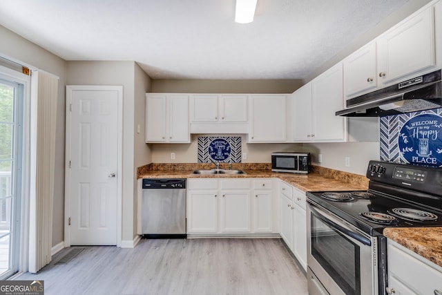 236 Fairview Dr, Dallas, GA 30157 - kitchen featuring stainless steel appliances, a sink, light wood-type flooring, under cabinet range hood, and white cabinetry