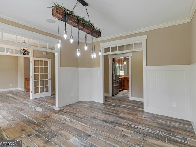 3905 Pointer Rd, Loganville, GA 30052 - empty room featuring ornamental molding, wainscoting, wood finished floors, a chandelier, and a decorative wall