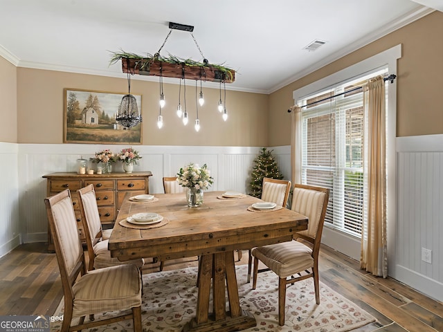 3905 Pointer Rd, Loganville, GA 30052 - dining area with ornamental molding, hardwood / wood-style flooring, and wainscoting