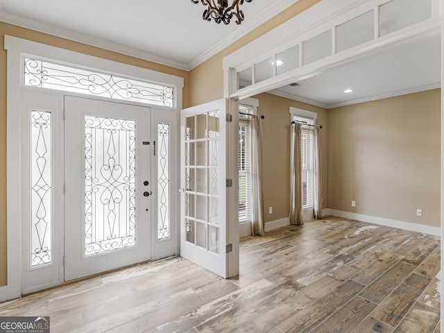 3905 Pointer Rd, Loganville, GA 30052 - entrance foyer featuring crown molding, wood finished floors, healthy amount of natural light, and a chandelier