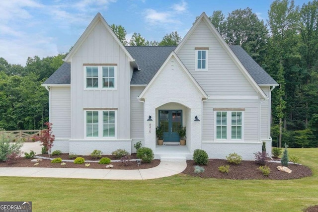 8415 Azure Overlook Trl, Gainesville, GA 30506 - view of front of property featuring board and batten siding, a front yard, french doors, roof with shingles, and brick siding