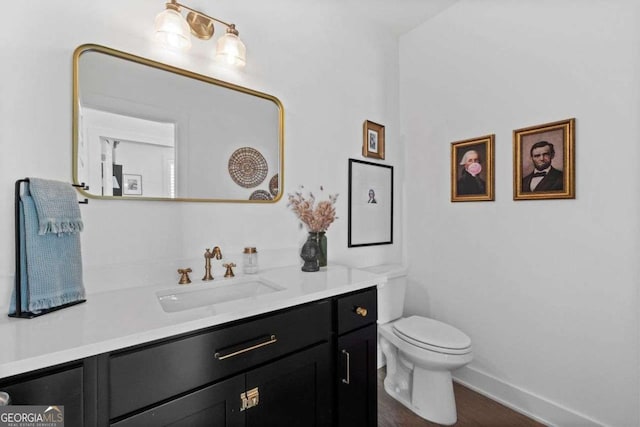 8415 Azure Overlook Trl, Gainesville, GA 30506 - bathroom featuring vanity, toilet, baseboards, and wood finished floors