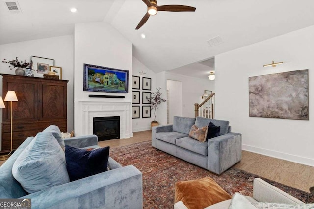 8415 Azure Overlook Trl, Gainesville, GA 30506 - living area featuring wood finished floors, lofted ceiling, a fireplace, ceiling fan, and baseboards