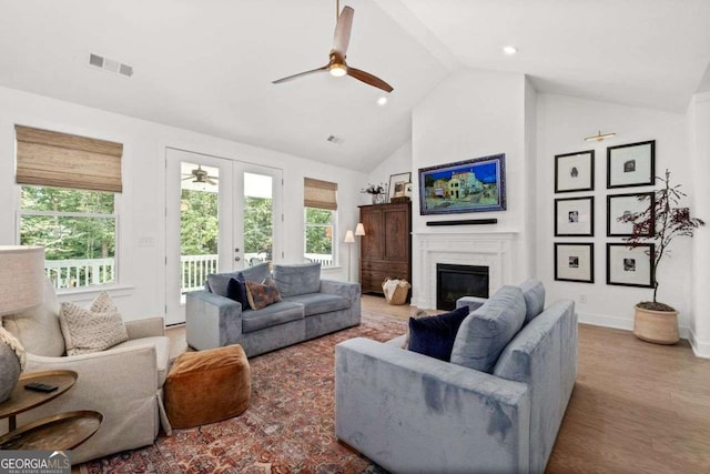 8415 Azure Overlook Trl, Gainesville, GA 30506 - living room with a ceiling fan, high vaulted ceiling, a glass covered fireplace, wood finished floors, and baseboards