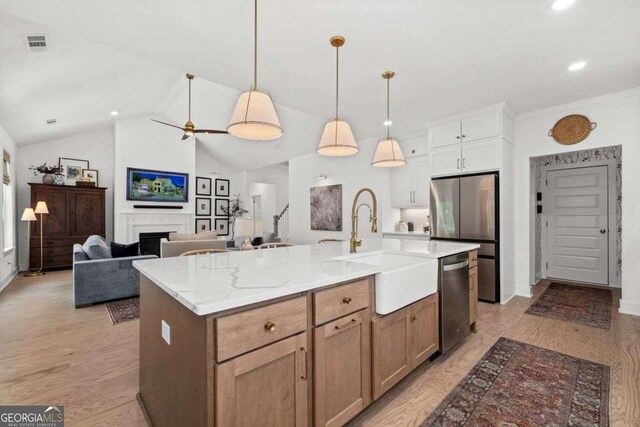 8415 Azure Overlook Trl, Gainesville, GA 30506 - kitchen with stainless steel appliances, a sink, vaulted ceiling, recessed lighting, and pendant lighting