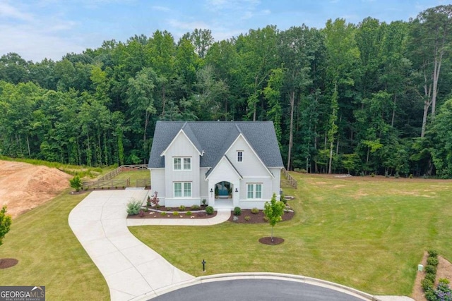 8415 Azure Overlook Trl, Gainesville, GA 30506 - view of front of house with driveway, board and batten siding, a front yard, and a wooded view
