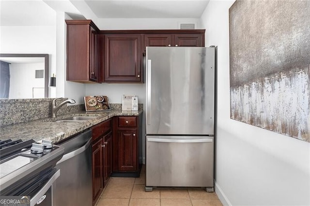 620 Peachtree St NE Unit 1206, Atlanta, GA 30308 - kitchen with stainless steel appliances, stone counters, and light tile patterned floors