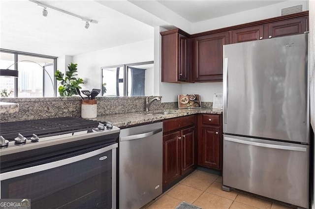 620 Peachtree St NE Unit 1206, Atlanta, GA 30308 - kitchen with stainless steel appliances, stone countertops, light tile patterned flooring, and track lighting