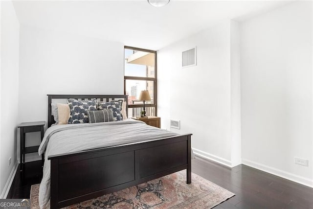 620 Peachtree St NE Unit 1206, Atlanta, GA 30308 - bedroom featuring wood finished floors and baseboards