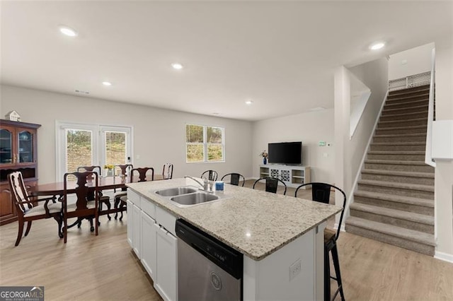352 Walnut Grove Way, Pendergrass, GA 30567 - kitchen featuring dishwasher, a sink, white cabinets, a breakfast bar area, and light wood-style flooring