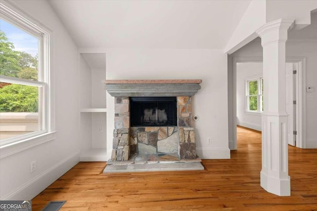 6771 Sunny Brook Ln, Atlanta, GA 30328 - detailed view of wood finished floors, a stone fireplace, and ornate columns