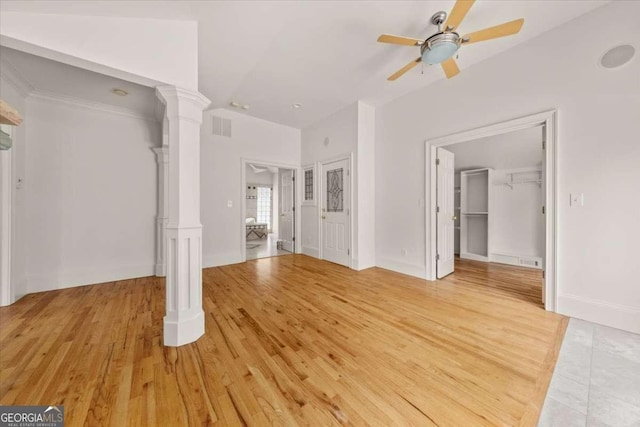 6771 Sunny Brook Ln, Atlanta, GA 30328 - unfurnished living room featuring a ceiling fan, light wood-type flooring, and ornate columns