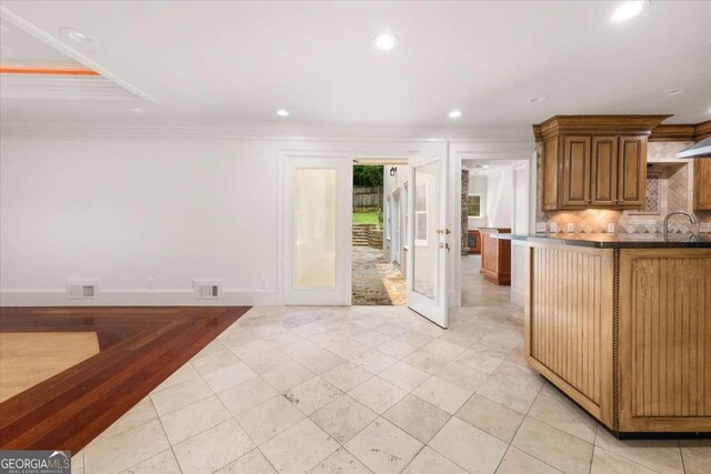 6771 Sunny Brook Ln, Atlanta, GA 30328 - kitchen with french doors, recessed lighting, decorative backsplash, crown molding, and light tile patterned floors
