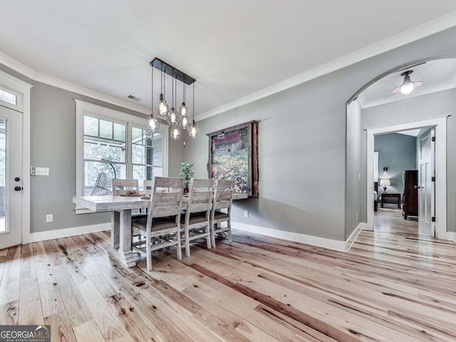 4454 Damascus Rd, Jasper, GA 30143 - dining area with light wood-type flooring, arched walkways, baseboards, crown molding, and a chandelier