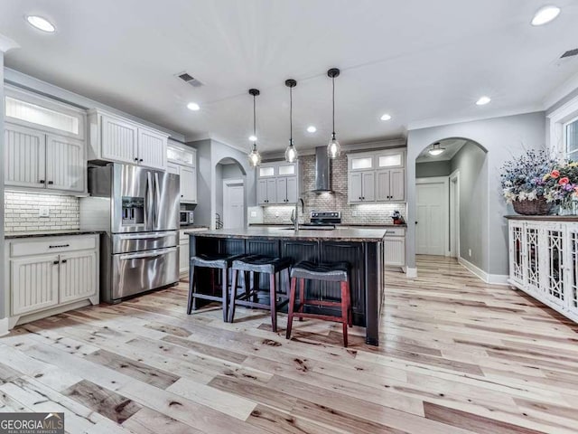 4454 Damascus Rd, Jasper, GA 30143 - kitchen featuring arched walkways, stainless steel refrigerator with ice dispenser, wall chimney exhaust hood, backsplash, and recessed lighting