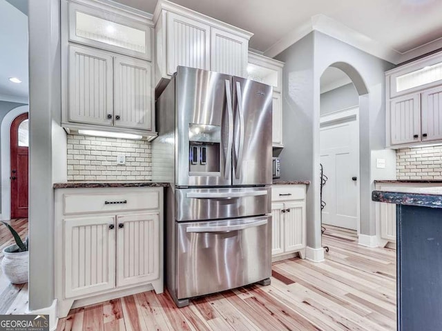 4454 Damascus Rd, Jasper, GA 30143 - kitchen featuring stainless steel refrigerator with ice dispenser, crown molding, light wood-style flooring, tasteful backsplash, and arched walkways