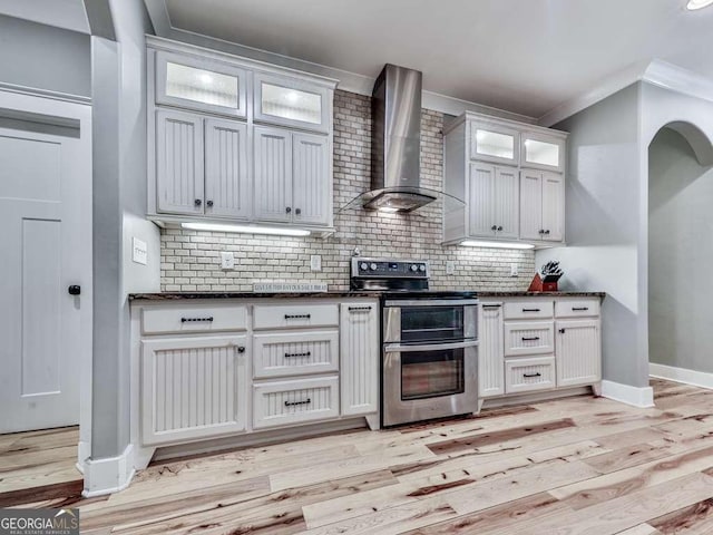 4454 Damascus Rd, Jasper, GA 30143 - kitchen with wall chimney exhaust hood, double oven range, light wood-style flooring, baseboards, and ornamental molding