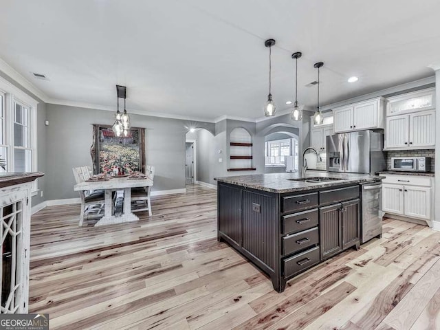 4454 Damascus Rd, Jasper, GA 30143 - kitchen featuring a sink, stainless steel appliances, light wood-style floors, arched walkways, and ornamental molding
