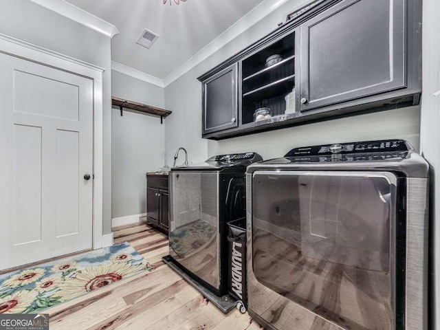 4454 Damascus Rd, Jasper, GA 30143 - washroom featuring washing machine and clothes dryer, ornamental molding, light wood-style floors, cabinet space, and baseboards