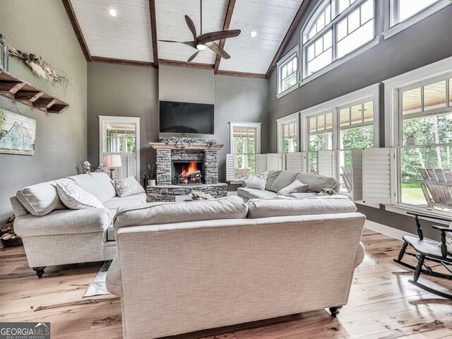 4454 Damascus Rd, Jasper, GA 30143 - living room with high vaulted ceiling, a ceiling fan, light wood-style floors, a fireplace, and wooden ceiling with exposed beams