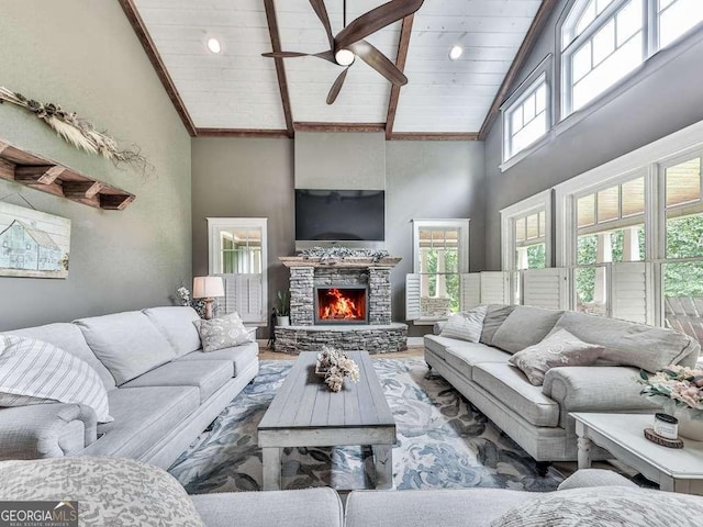 4454 Damascus Rd, Jasper, GA 30143 - living room with high vaulted ceiling, ceiling fan, a stone fireplace, wooden ceiling with exposed beams, and wood finished floors
