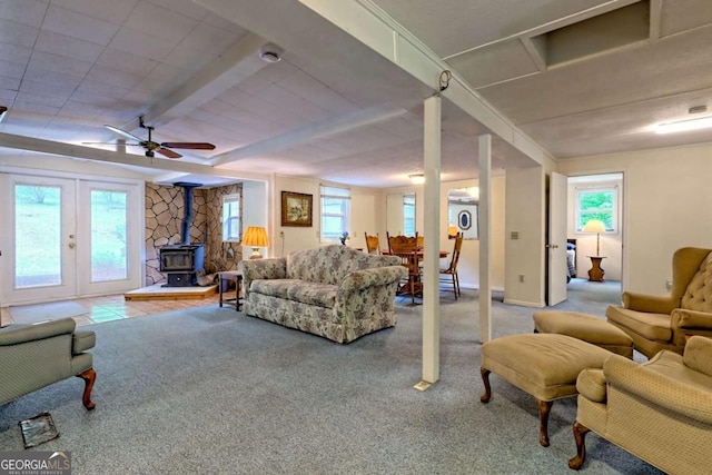 4618 Jones Gap Rd, Hiawassee, GA 30546 - living room featuring a wood stove, healthy amount of natural light, a ceiling fan, and carpet
