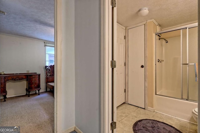 4618 Jones Gap Rd, Hiawassee, GA 30546 - full bath with a textured ceiling, shower / bath combination with glass door, toilet, tile patterned floors, and baseboards