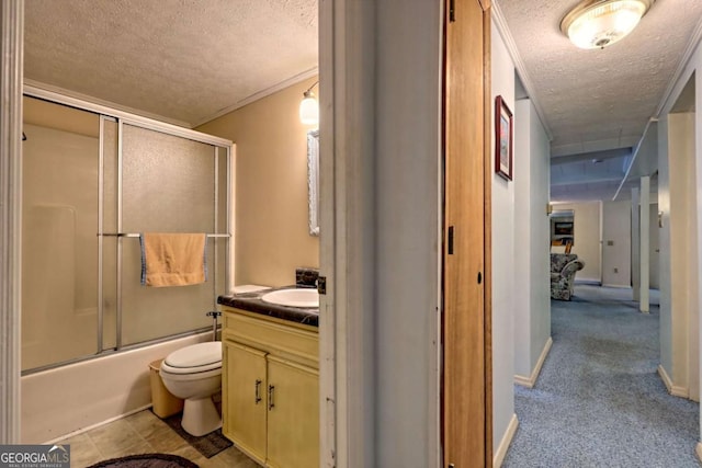 4618 Jones Gap Rd, Hiawassee, GA 30546 - bathroom featuring a textured ceiling, vanity, toilet, combined bath / shower with glass door, and baseboards