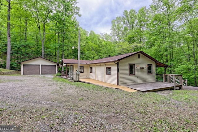 4618 Jones Gap Rd, Hiawassee, GA 30546 - single story home featuring an outdoor structure, a wooden deck, a detached garage, and a forest view