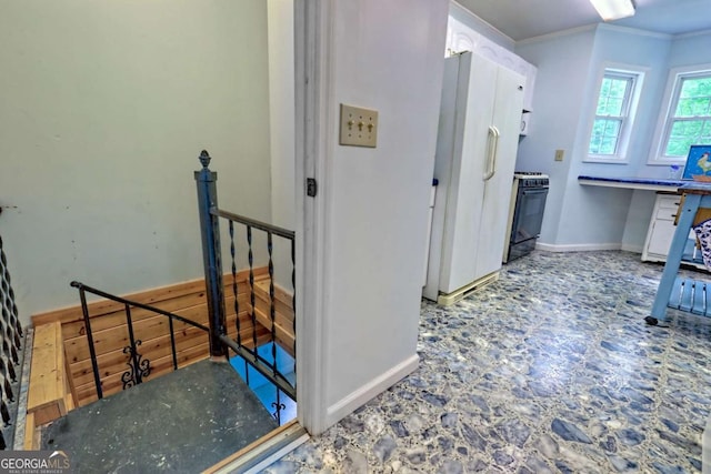 4618 Jones Gap Rd, Hiawassee, GA 30546 - kitchen featuring range with gas stovetop, freestanding refrigerator, baseboards, ornamental molding, and white cabinets