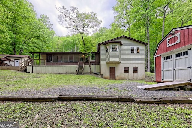 4618 Jones Gap Rd, Hiawassee, GA 30546 - back of property featuring a sunroom, stairs, and a garage