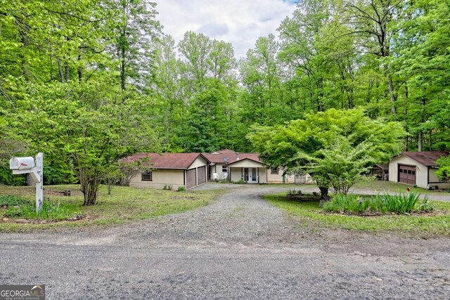 4618 Jones Gap Rd, Hiawassee, GA 30546 - ranch-style house featuring dirt driveway and a garage