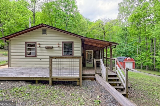 4618 Jones Gap Rd, Hiawassee, GA 30546 - rear view of house featuring a wooden deck, an outbuilding, and a forest view