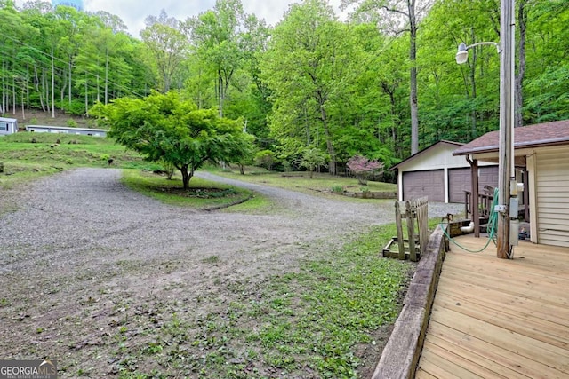 4618 Jones Gap Rd, Hiawassee, GA 30546 - view of yard featuring an outdoor structure, driveway, and a forest view