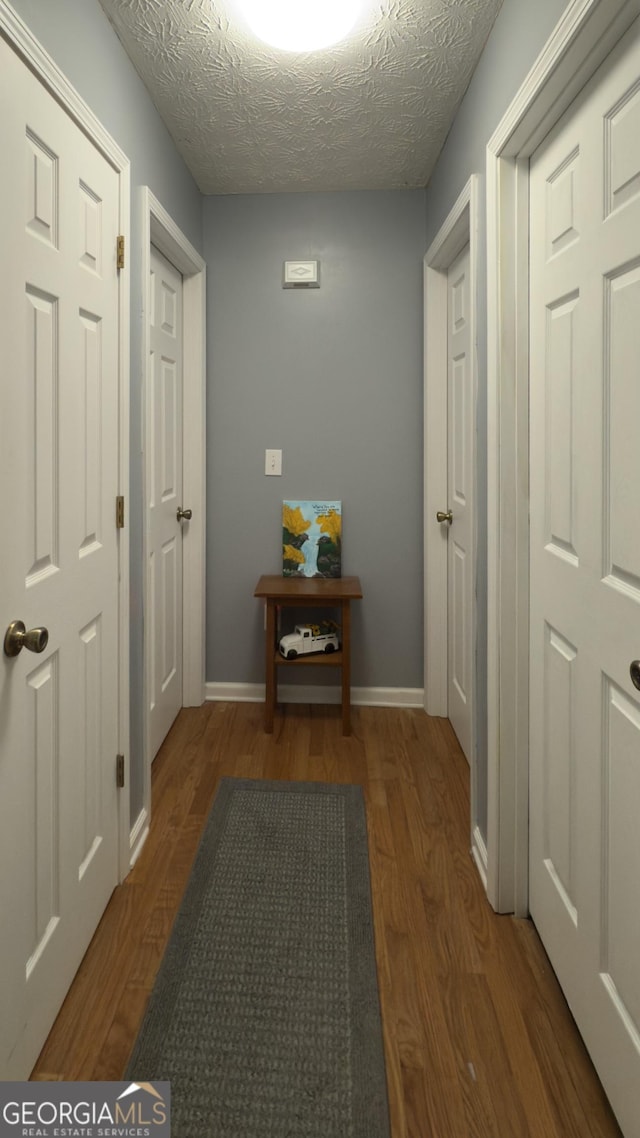 50 Kensington Dr, Cleveland, GA 30528 - corridor with wood finished floors, a textured ceiling, and baseboards