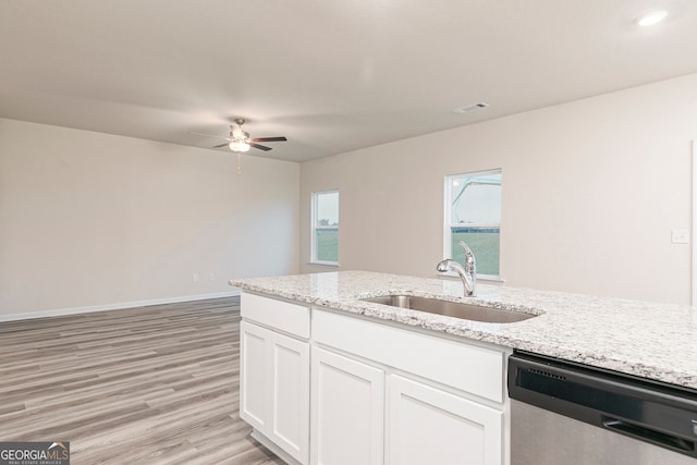 295 Limestone Cir, Conyers, GA 30013 - kitchen with stainless steel dishwasher, a sink, a ceiling fan, light wood-style floors, and white cabinets