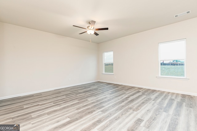 295 Limestone Cir, Conyers, GA 30013 - empty room with light wood finished floors, ceiling fan, and baseboards