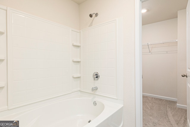 295 Limestone Cir, Conyers, GA 30013 - bathroom with  shower combination, a spacious closet, and baseboards