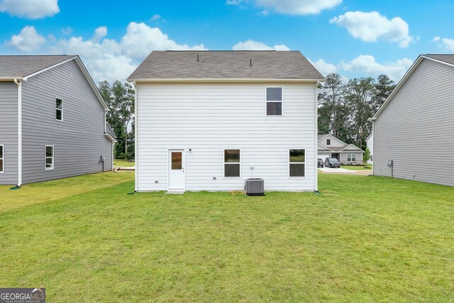 295 Limestone Cir, Conyers, GA 30013 - back of house with a yard, a shingled roof, and central AC