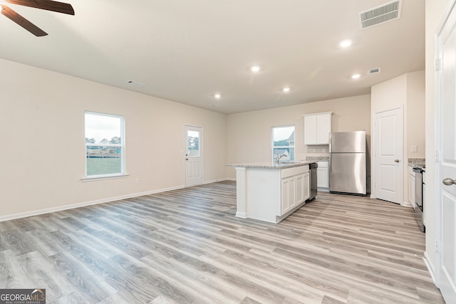 295 Limestone Cir, Conyers, GA 30013 - kitchen featuring appliances with stainless steel finishes, recessed lighting, a sink, light wood-style floors, and open floor plan