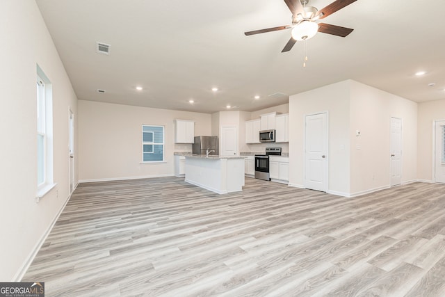 295 Limestone Cir, Conyers, GA 30013 - kitchen with stainless steel appliances, open floor plan, recessed lighting, light wood-type flooring, and baseboards