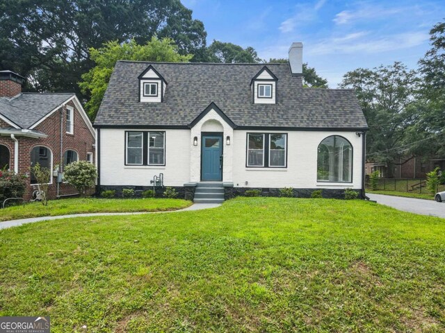 1283 Beecher St SW, Atlanta, GA 30310 - view of front facade with a chimney, a front yard, and brick siding