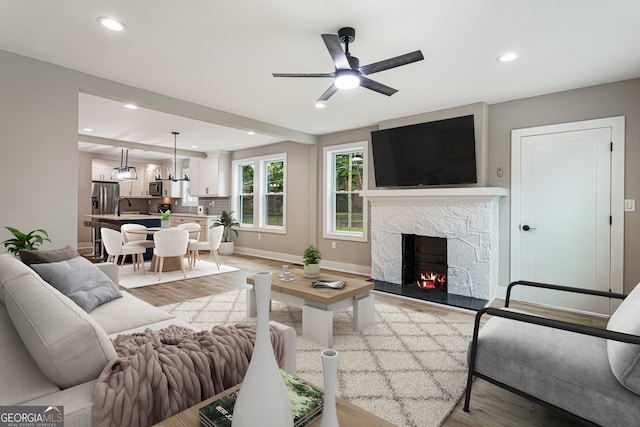 1283 Beecher St SW, Atlanta, GA 30310 - living room with light wood finished floors, a ceiling fan, a fireplace, and recessed lighting