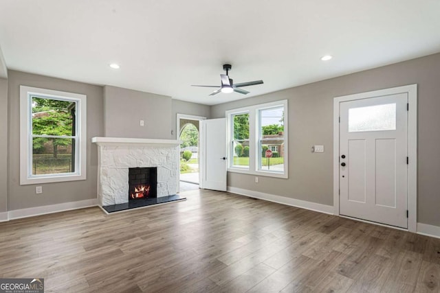 1283 Beecher St SW, Atlanta, GA 30310 - unfurnished living room with a ceiling fan, a stone fireplace, wood finished floors, and recessed lighting
