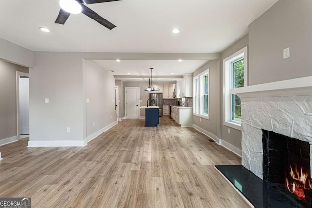 1283 Beecher St SW, Atlanta, GA 30310 - unfurnished living room featuring a fireplace, ceiling fan, light wood-style flooring, and recessed lighting