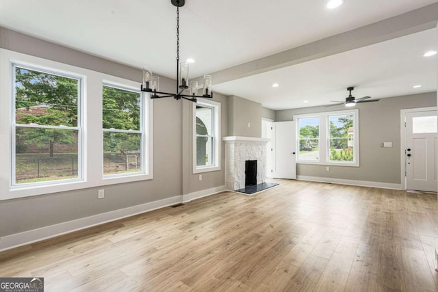 1283 Beecher St SW, Atlanta, GA 30310 - unfurnished living room featuring light wood finished floors, a premium fireplace, a chandelier, recessed lighting, and a ceiling fan