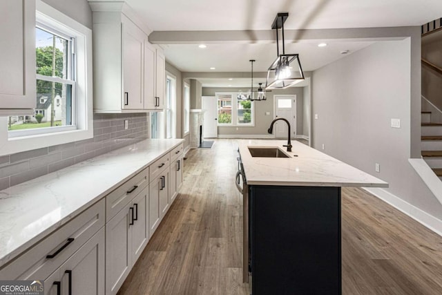 1283 Beecher St SW, Atlanta, GA 30310 - kitchen with an island with sink, light wood-style flooring, backsplash, healthy amount of natural light, and recessed lighting