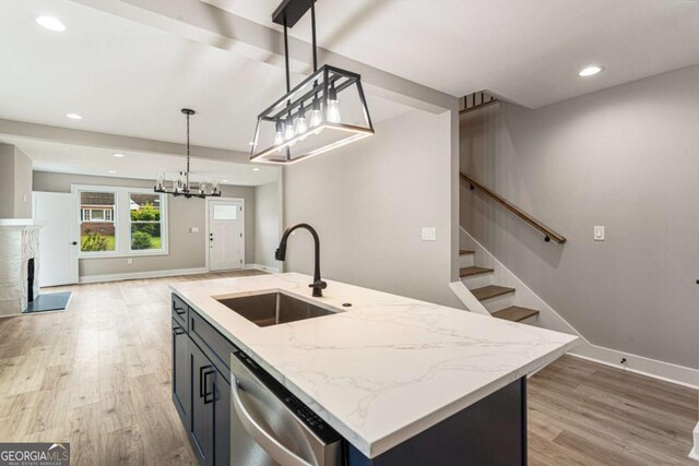 1283 Beecher St SW, Atlanta, GA 30310 - kitchen with stainless steel dishwasher, light wood-style floors, light stone countertops, decorative light fixtures, and recessed lighting