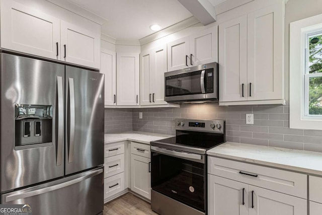 1283 Beecher St SW, Atlanta, GA 30310 - kitchen featuring appliances with stainless steel finishes, white cabinets, tasteful backsplash, and light stone countertops